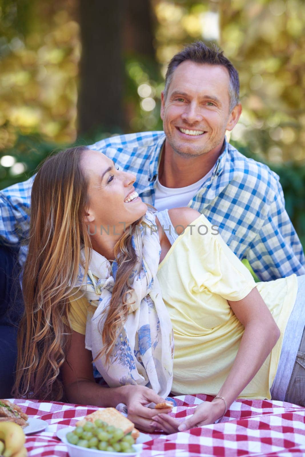 Mature couple, picnic and bonding in outdoor nature, love and romance in relationship on weekend. Man, portrait and people on date in countryside, smile and adventure in forest or happy on vacation by YuriArcurs