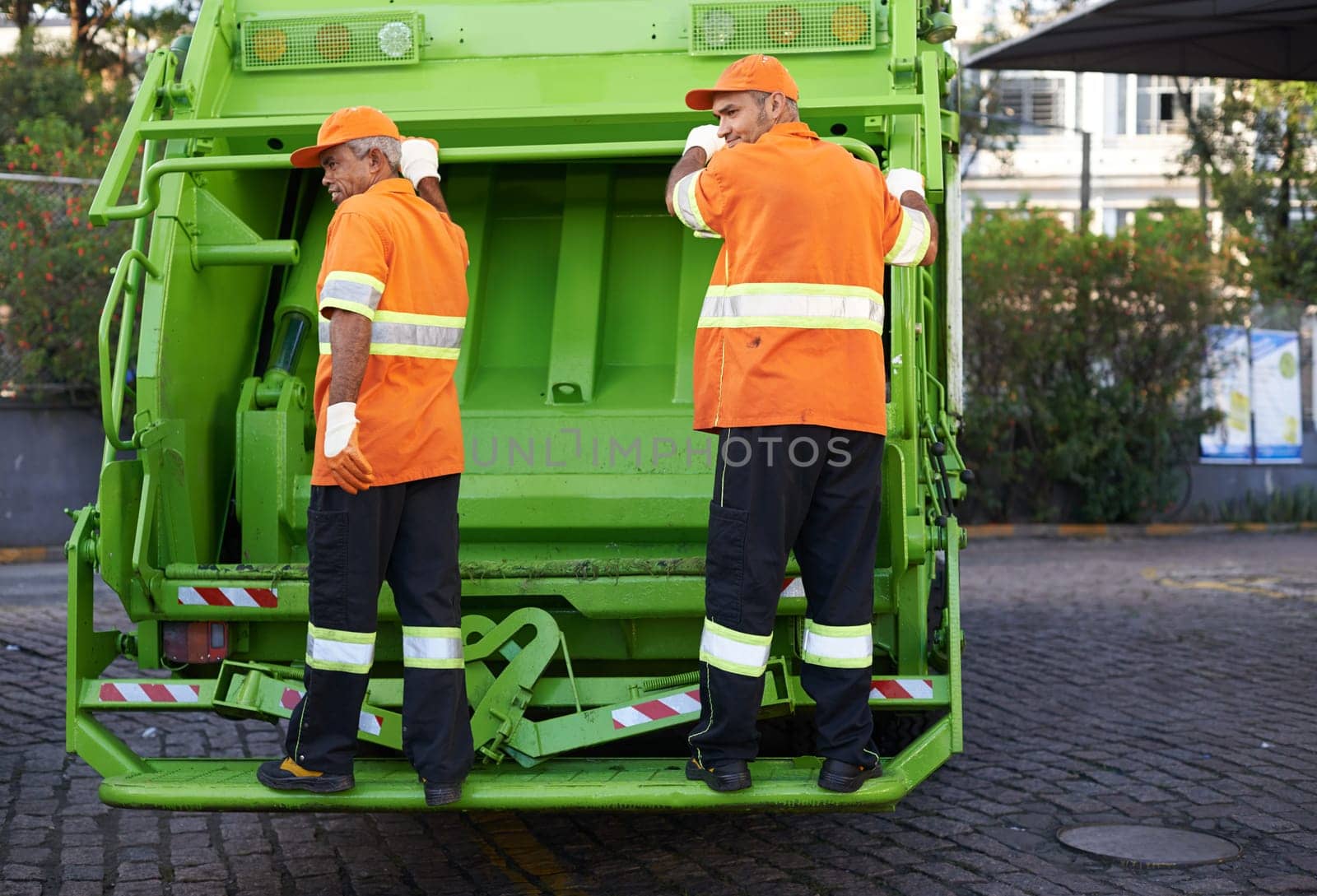 Garbage collector, service and truck for waste management and teamwork with routine and cleaning the city. Road, recycling and environment with transportation and green energy with trash or street.