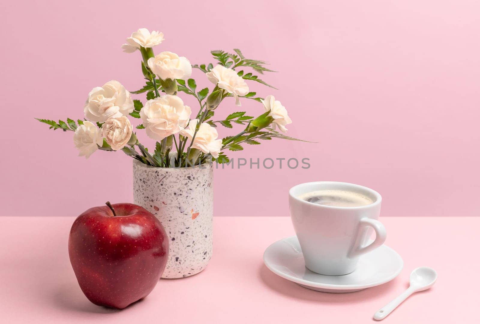 Bouquet of carnations in a vase with a an apple and a cup of coffee. by mvg6894