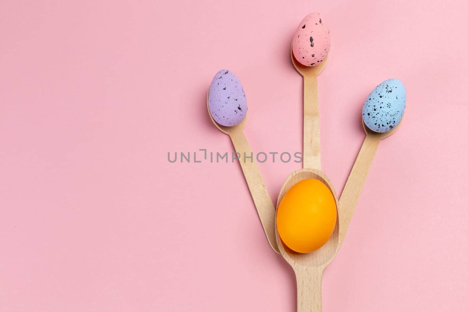 Colored Easter eggs with the wooden spoons. by mvg6894