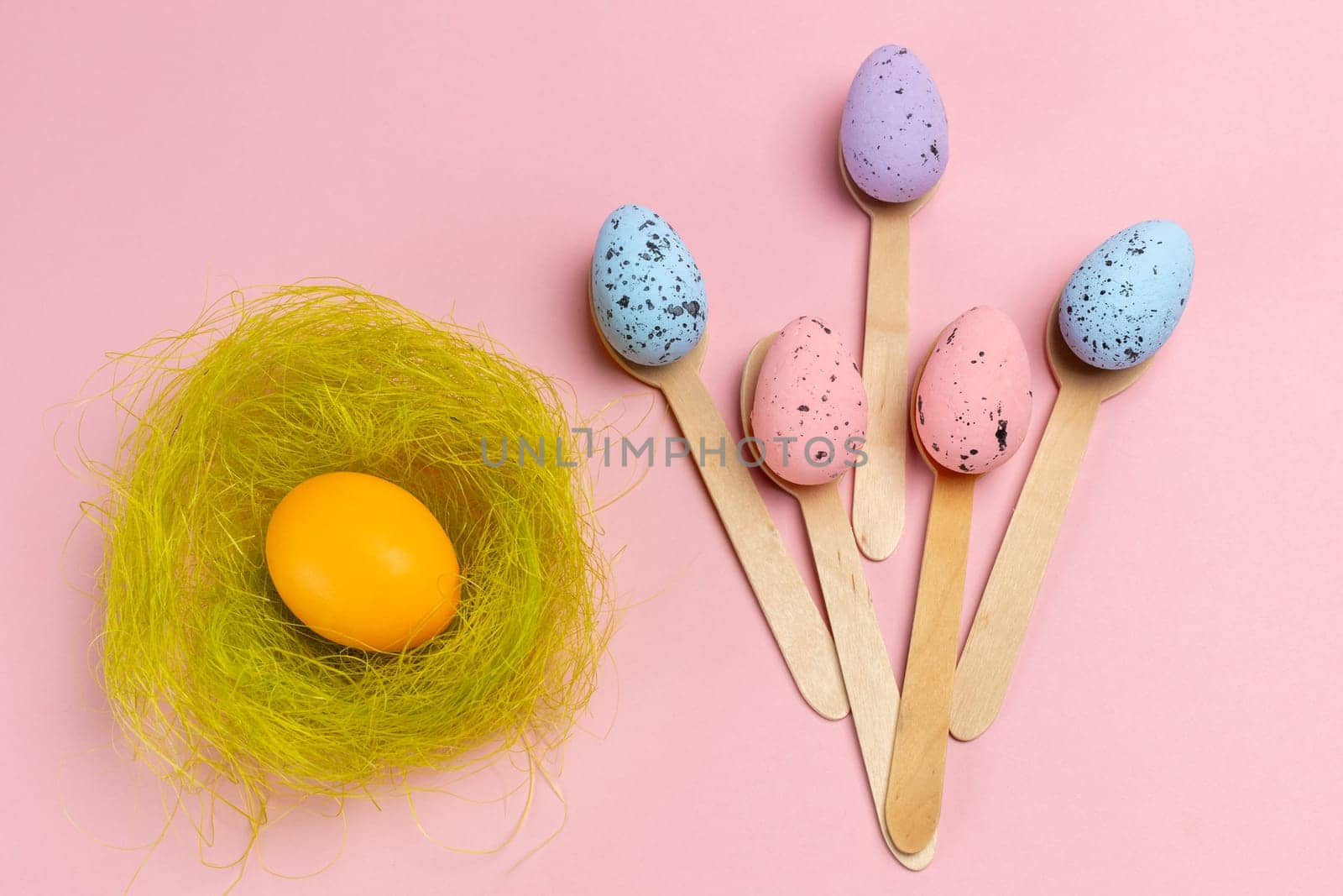 Colored Easter eggs with the nest and the wooden spoons. by mvg6894