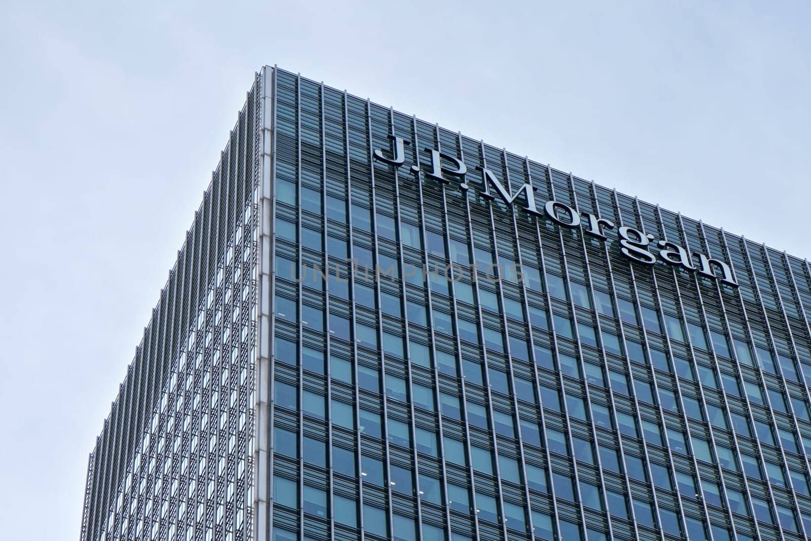 London, United Kingdom - February 03, 2019: Sun shines on J P Morgan signage at top of their UK branch at Canary Wharf. JPMorgan Chase is US multinational investment bank founded (originally) 1799 by Ivanko