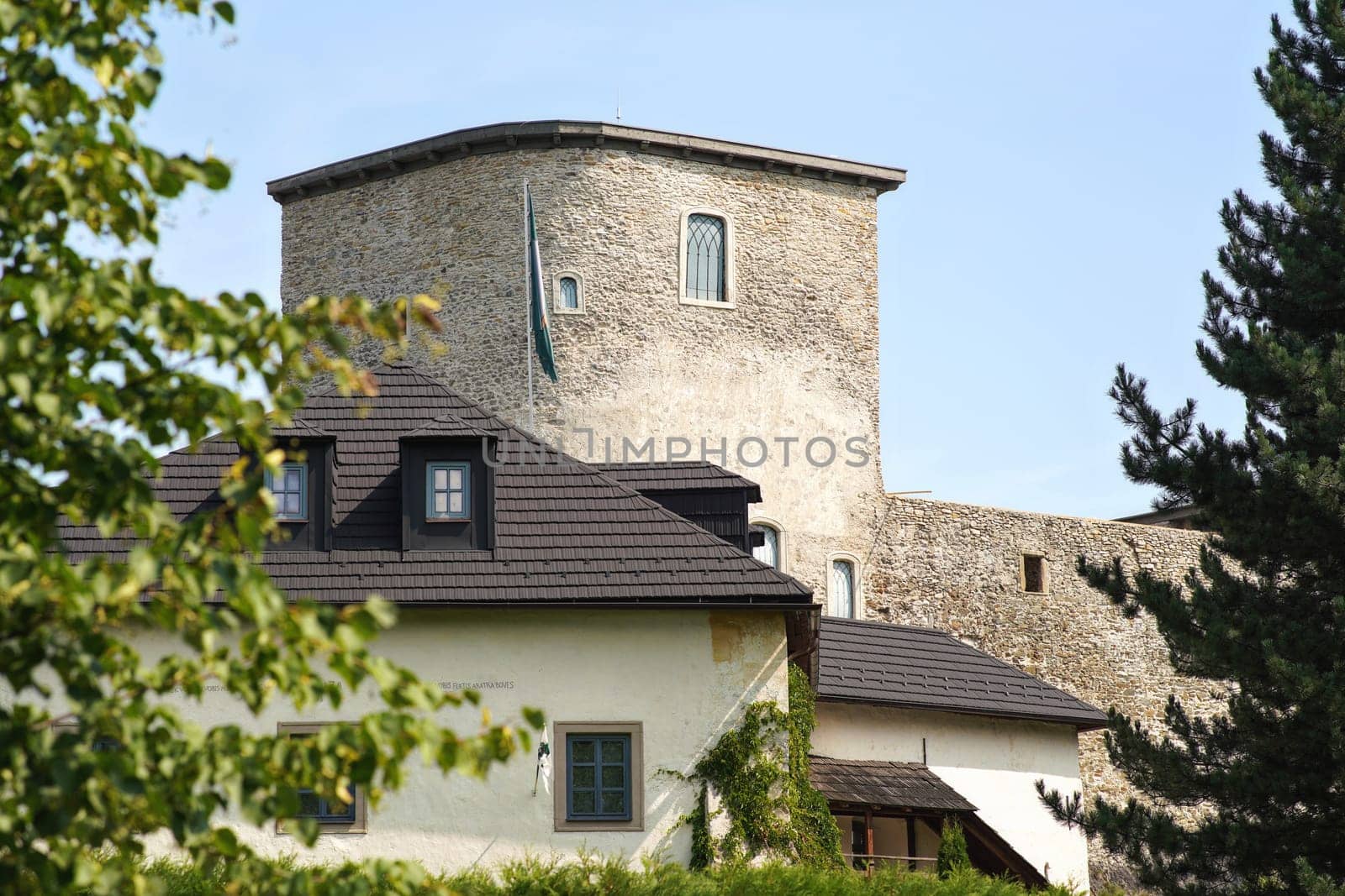 Liptovsky Hradok, Slovakia - May 27, 2018: Castle "Novy hrad" (first written record to "Wywar" fort dated 1341), view from front blurred trees in foreground by Ivanko