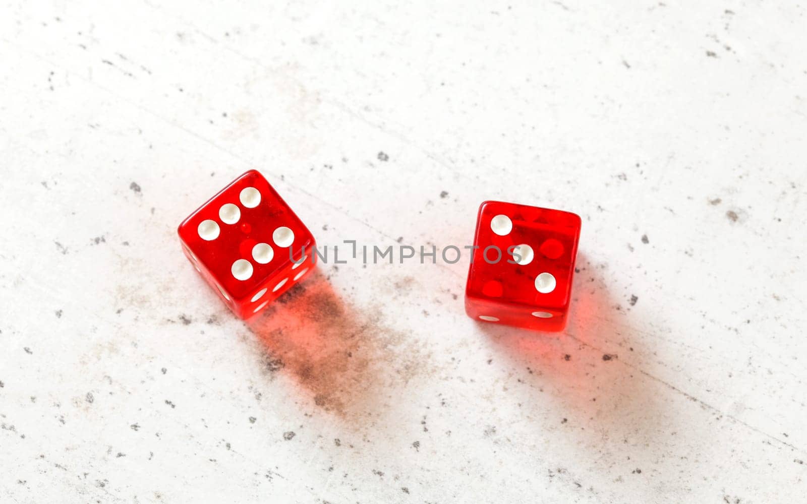 Two red craps dices showing Centerfield Nine (Nina) (number 6 and 3) overhead shot on white board