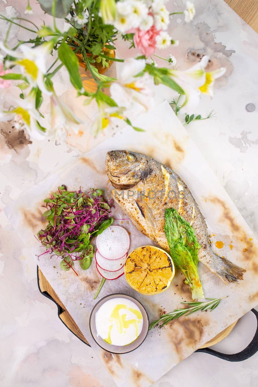 Grilled fish with lemon and herbs on a white background by Pukhovskiy