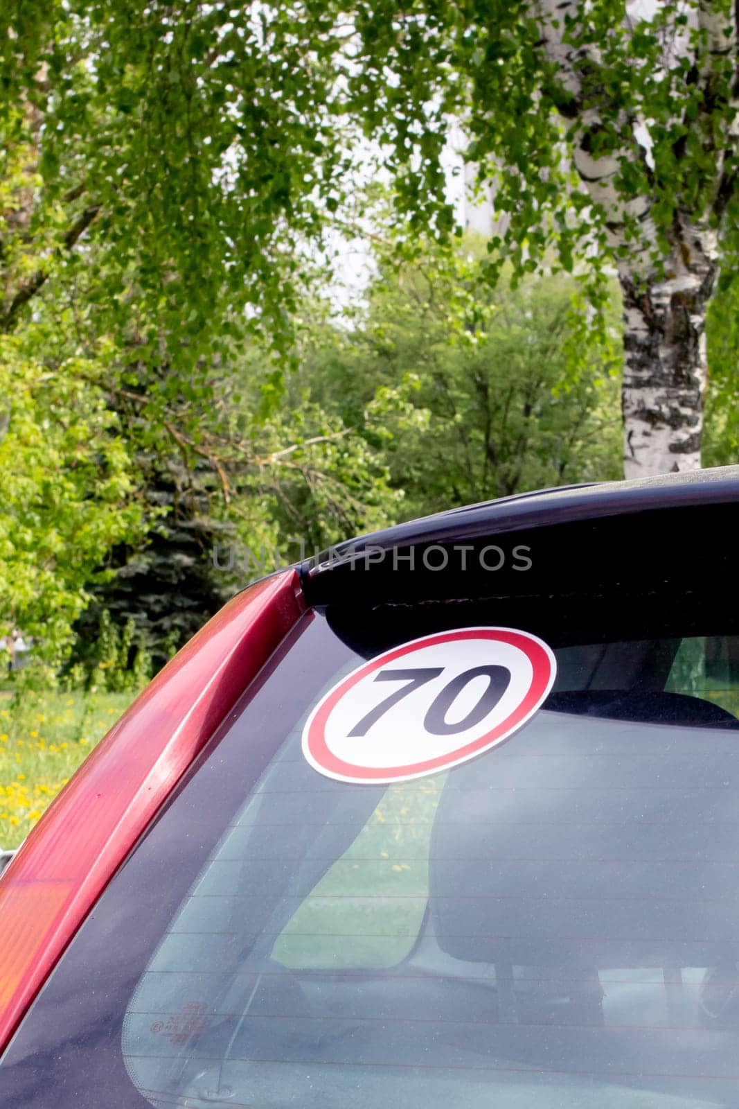 Sticker 70 on the rear window of the car close up