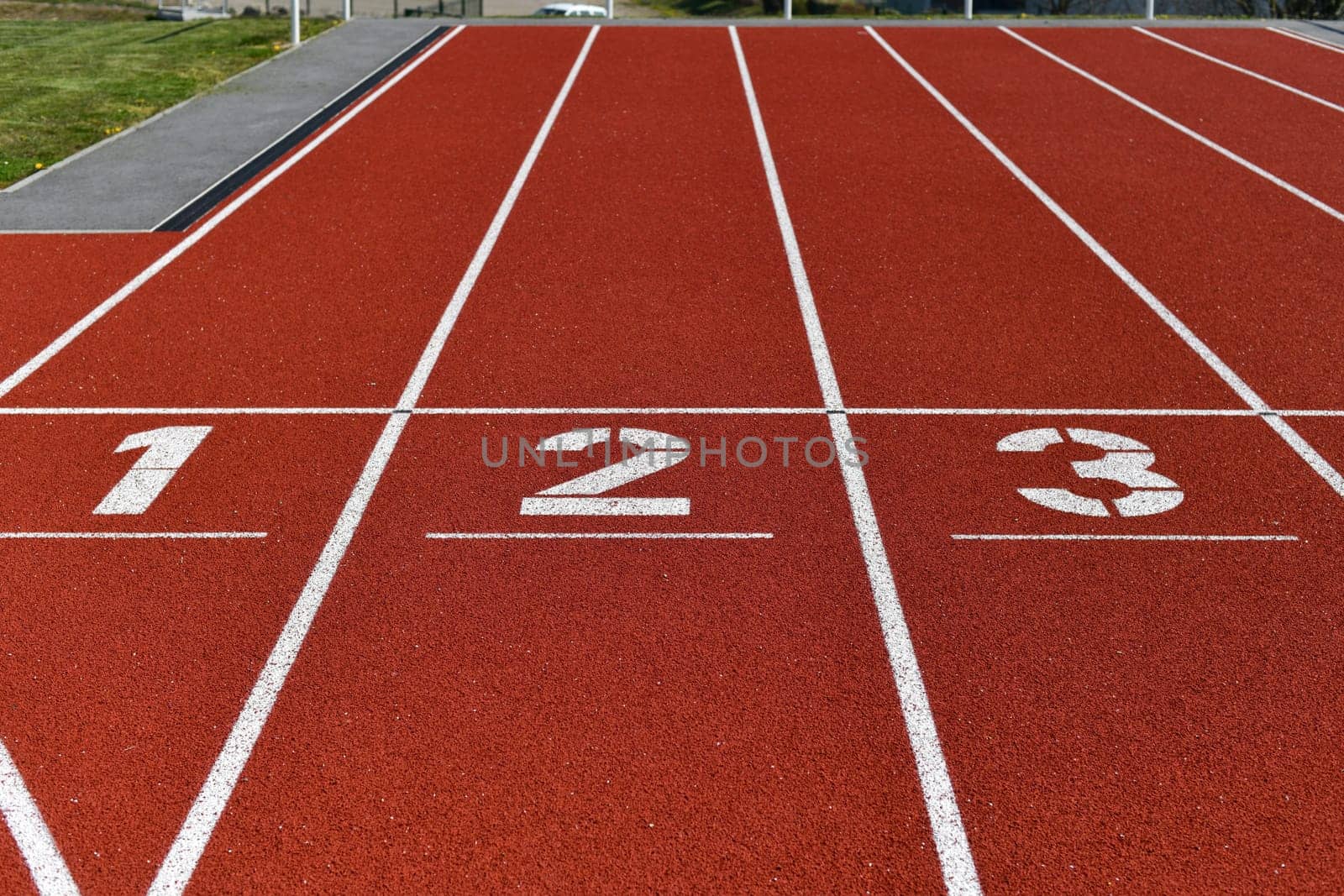 The red runway is numbered in a stadium