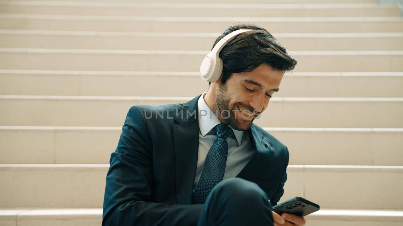 Closeup of business man listen and enjoy music while wear headphone. Exultant. by biancoblue