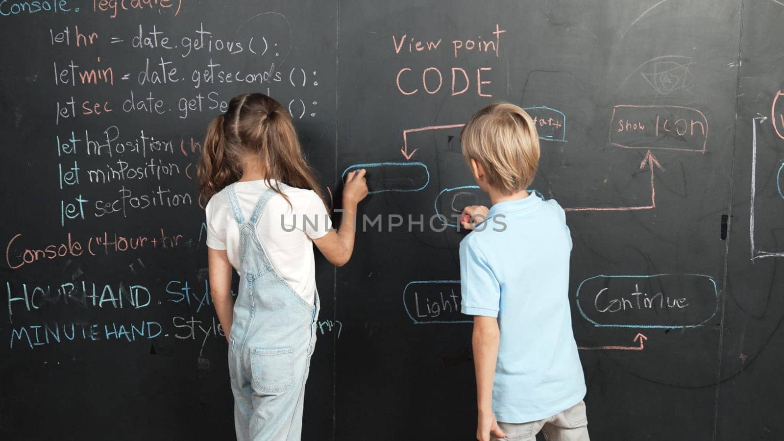 Caucasian girl and smart boy writing blackboard with engineering prompt or coding, programing system written in STEM technology classroom. Young cute student working together at blackboard. Erudition.