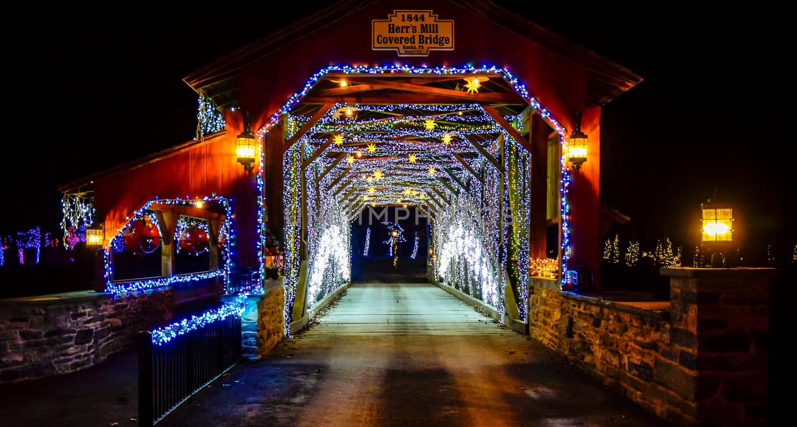 Elizabethtown, Pennsylvania, USA, December 8,2023 - Twinkling Blue And White Lights Line The Interior Of Herr's Mill Covered Bridge From 1844, Creating A Festive Tunnel Effect At Night,