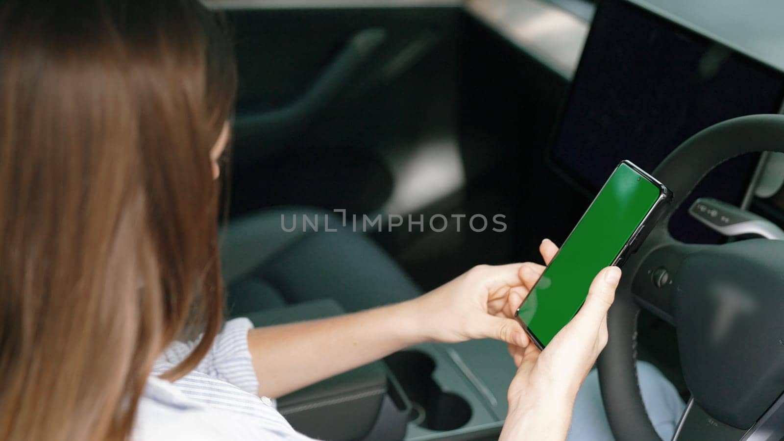 Eco-conscious woman on driver seat holding blank copyspace screen phone. Exalt by biancoblue