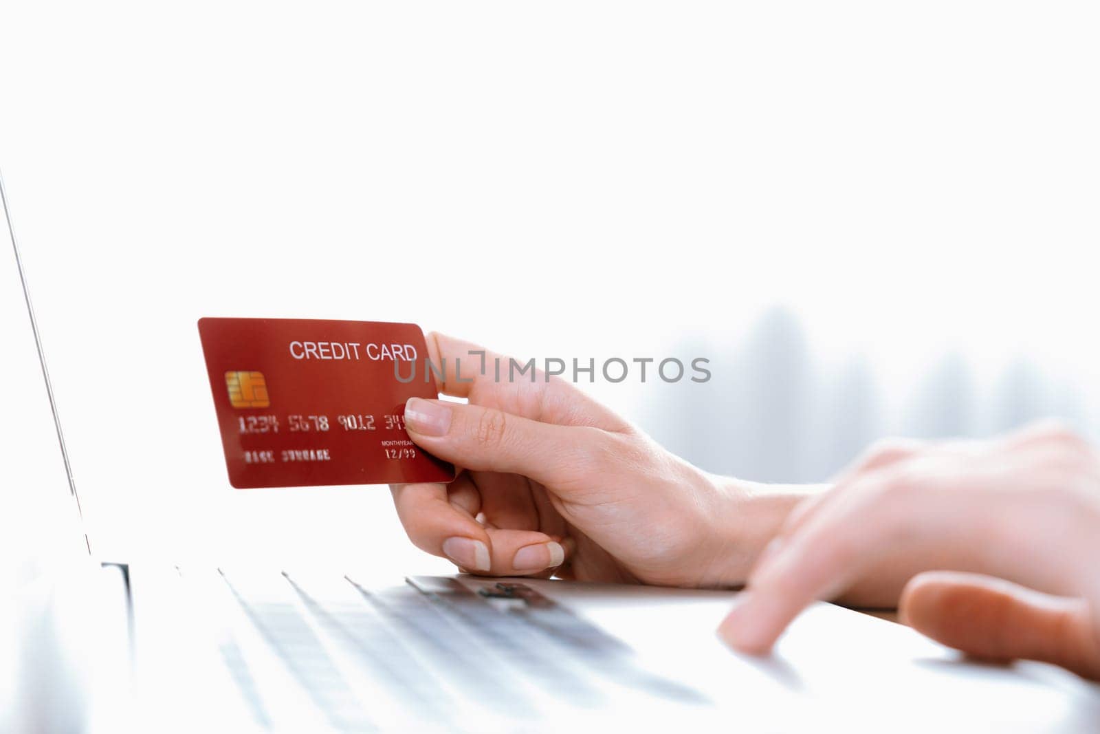 Close up credit card using for online payment, banking and shopping on the internet network with laptop computer showing credit card technology for online secured wallet top up and utmost purchase