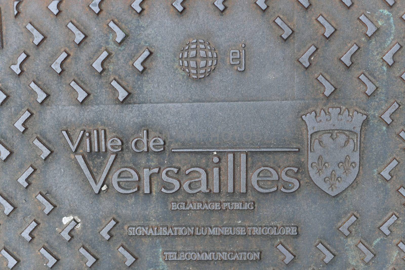 VERSAILLES, FRANCE - AUGUST 09,2023 : Decorated manhole cover at Versailles a city in France. by Godi