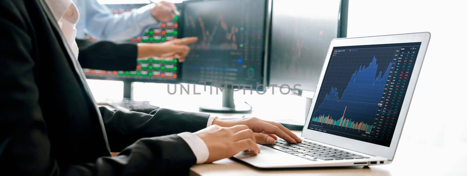 Cropped image of group of expert professional treader discuss about stock market graph show increasing graph while point on the computer display at office. Money exchange, growth chart. Burgeoning.