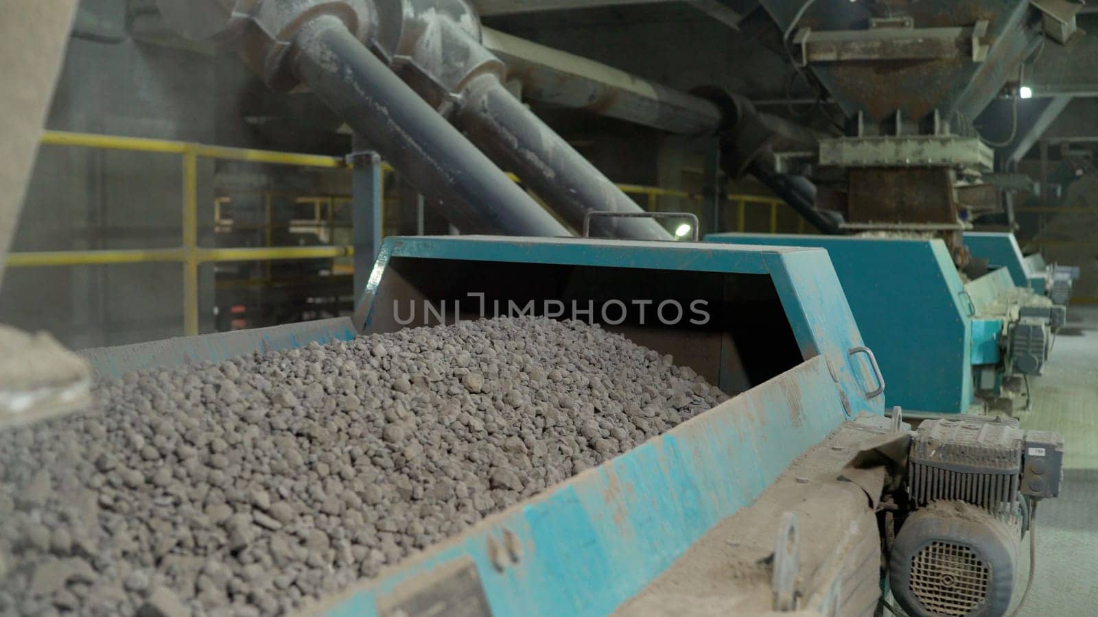 Cement additives at the plant. Close-up of bulk materials in a factory. Processing of raw additives in bulk at the plant. Crushed stone for addition to cement.