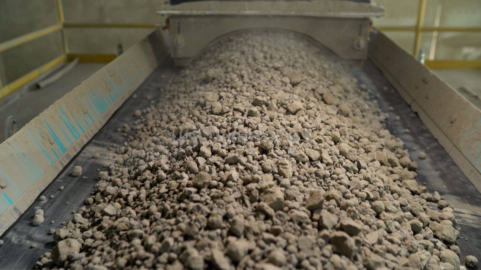 Close-up of bulk materials in a factory. Processing of raw additives in bulk at the plant. Crushed stone for addition to cement. Cement additives at the plant. by Rusrussid