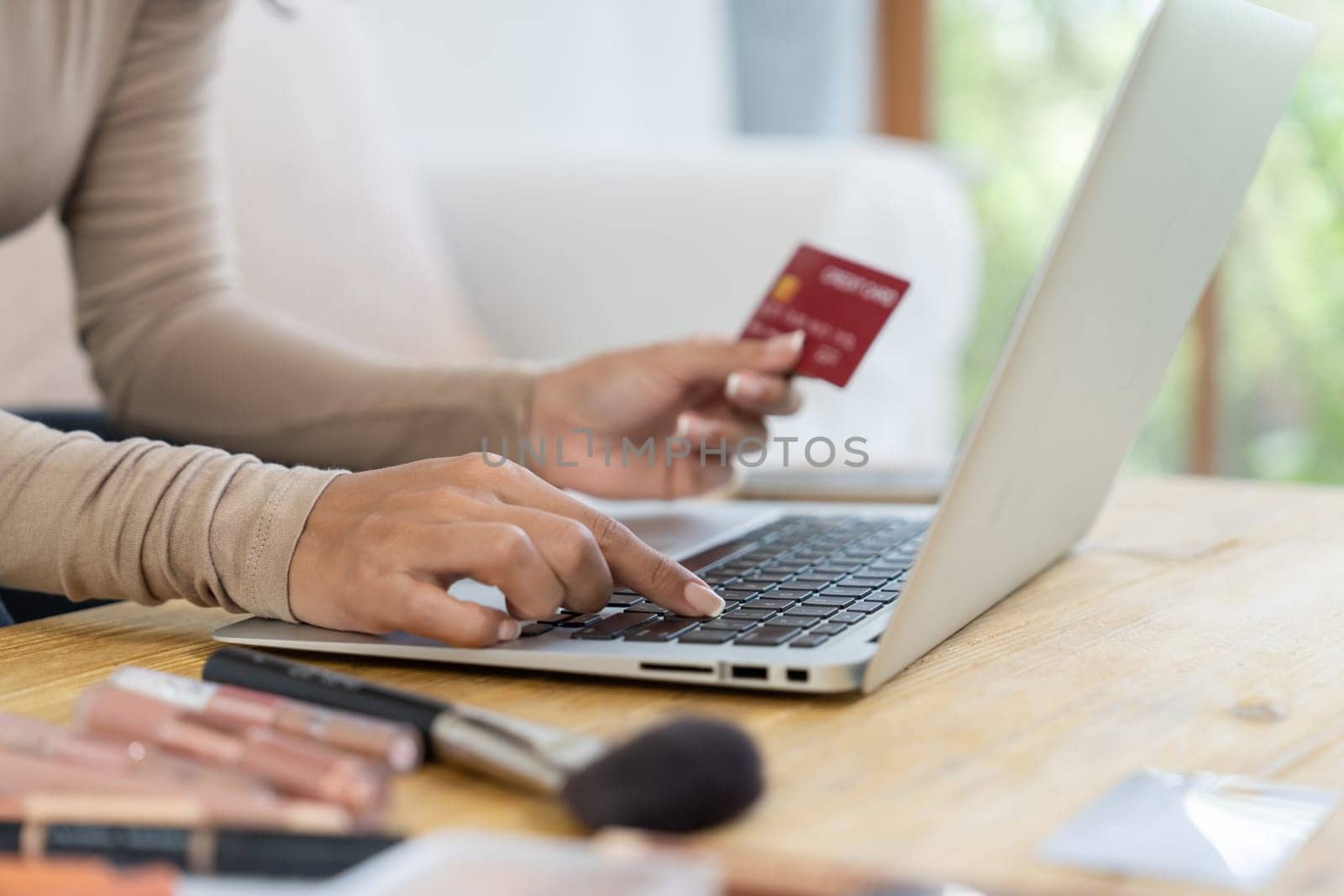 Close up credit card using for online payment, banking and shopping on the internet network with laptop computer showing credit card technology for online secured wallet top up and crucial purchase