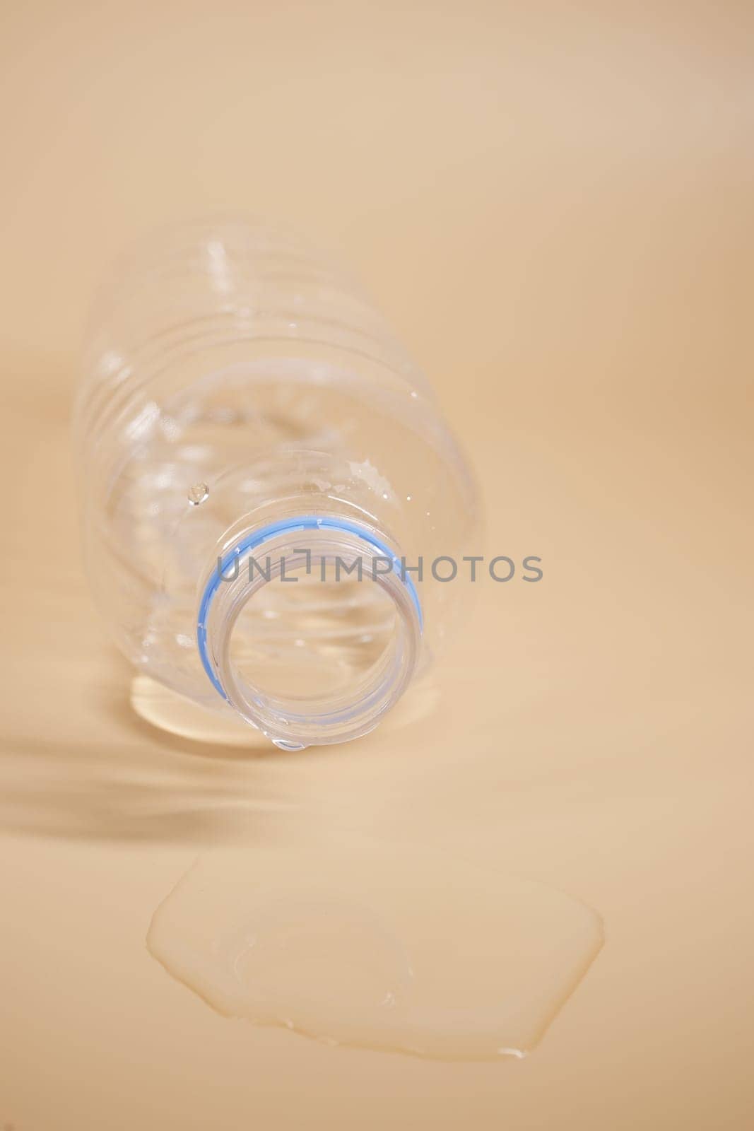 top view of a bottle of water spilled on a floor , by towfiq007