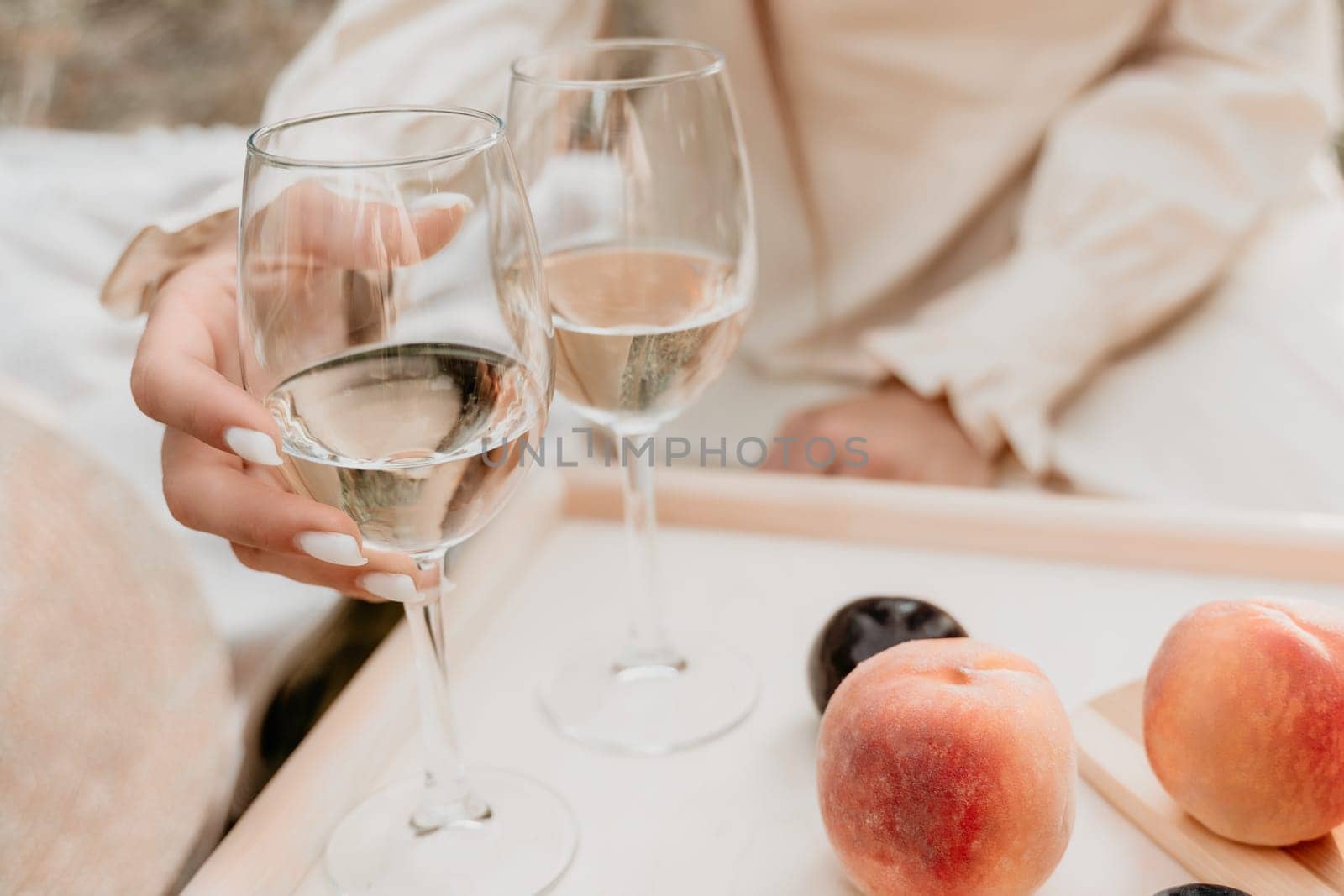 Picnic and wine tasting at sunset in the hills of Italy, Tuscany. Vineyards and open nature in the summer. Romantic dinner, fruit and wine.