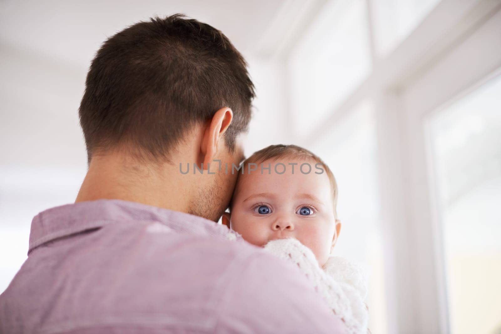 Father, baby and home with portrait, support and bonding together with newborn and love. Happy, family and dad with young child in a living room with parent care in a house carrying a calm infant.