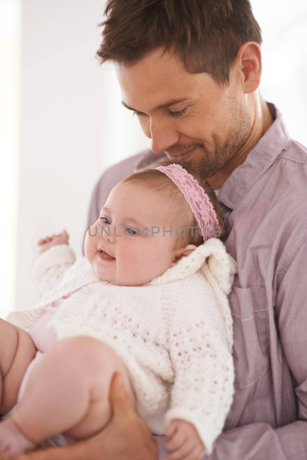 Family, baby and dad in home with love, support and youth with parent and bonding. Relax, father and happy in a house with hug of calm infant with childcare and smile with a girl in living room.