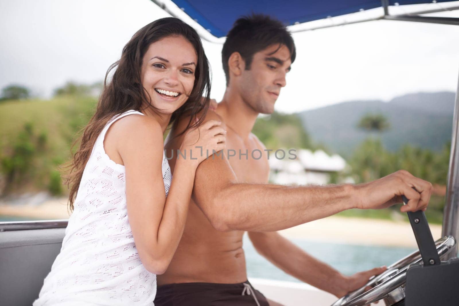 Couple, boat and driving for lake holiday or explore sea on vacation adventure or sailing, travel or steering wheel. Man, woman and happy in Hawaii or outdoor journey on coast, transportation or trip by YuriArcurs