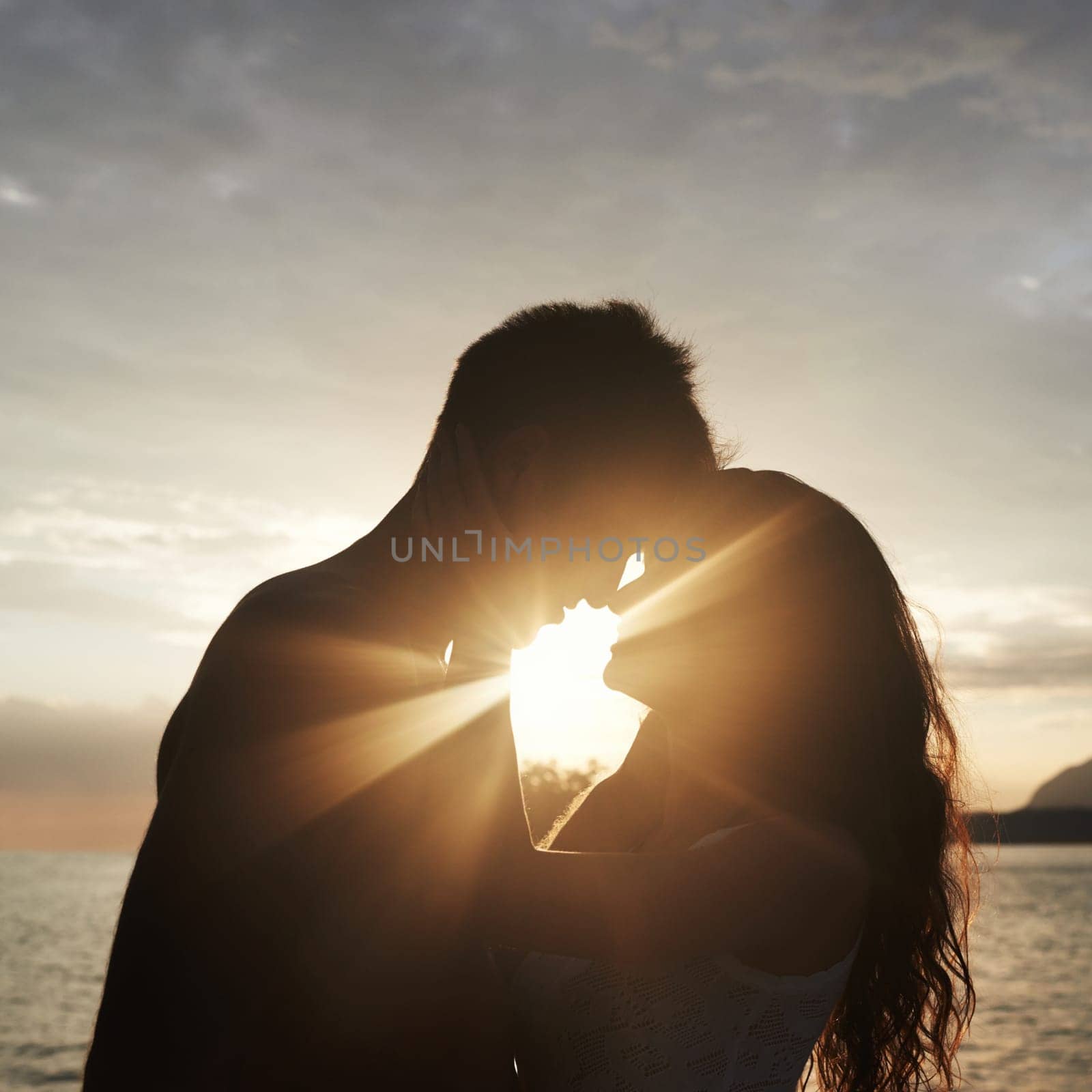 Silhouette, couple and face at ocean for sunset, vacation or travel together in summer on lens flare. Man, woman and romance at sea with shadow for connection, love and adventure by water outdoor by YuriArcurs