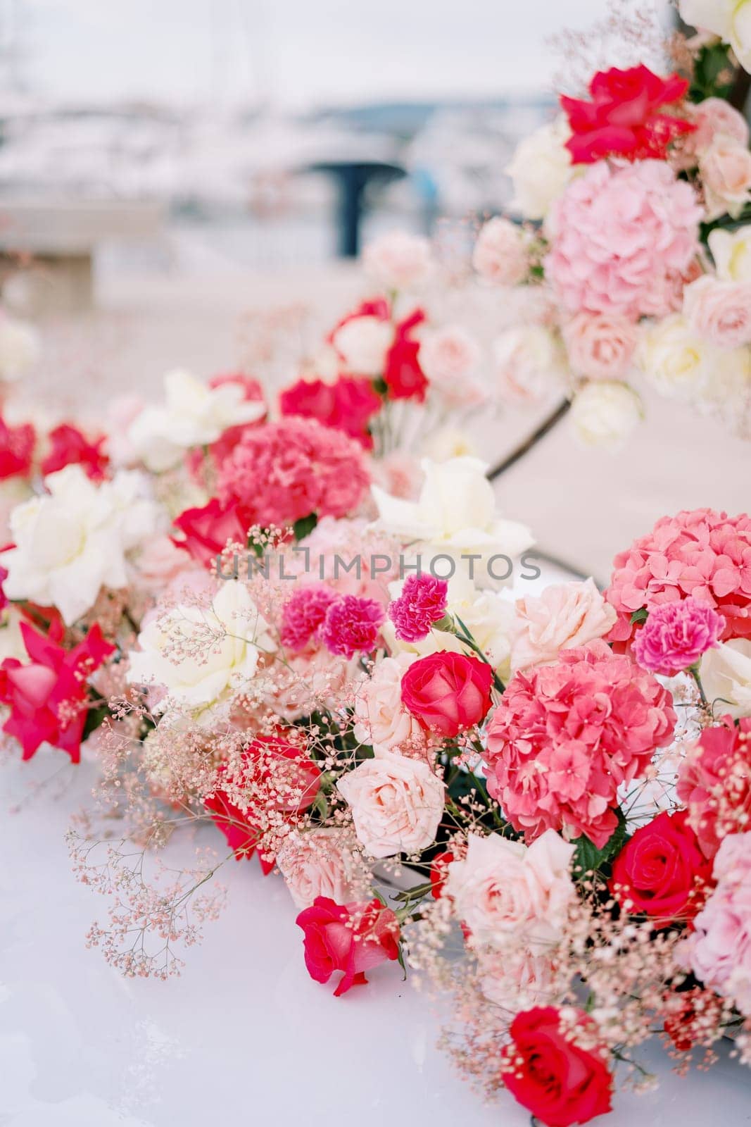 Bouquet of colorful flowers stands on the pier by Nadtochiy