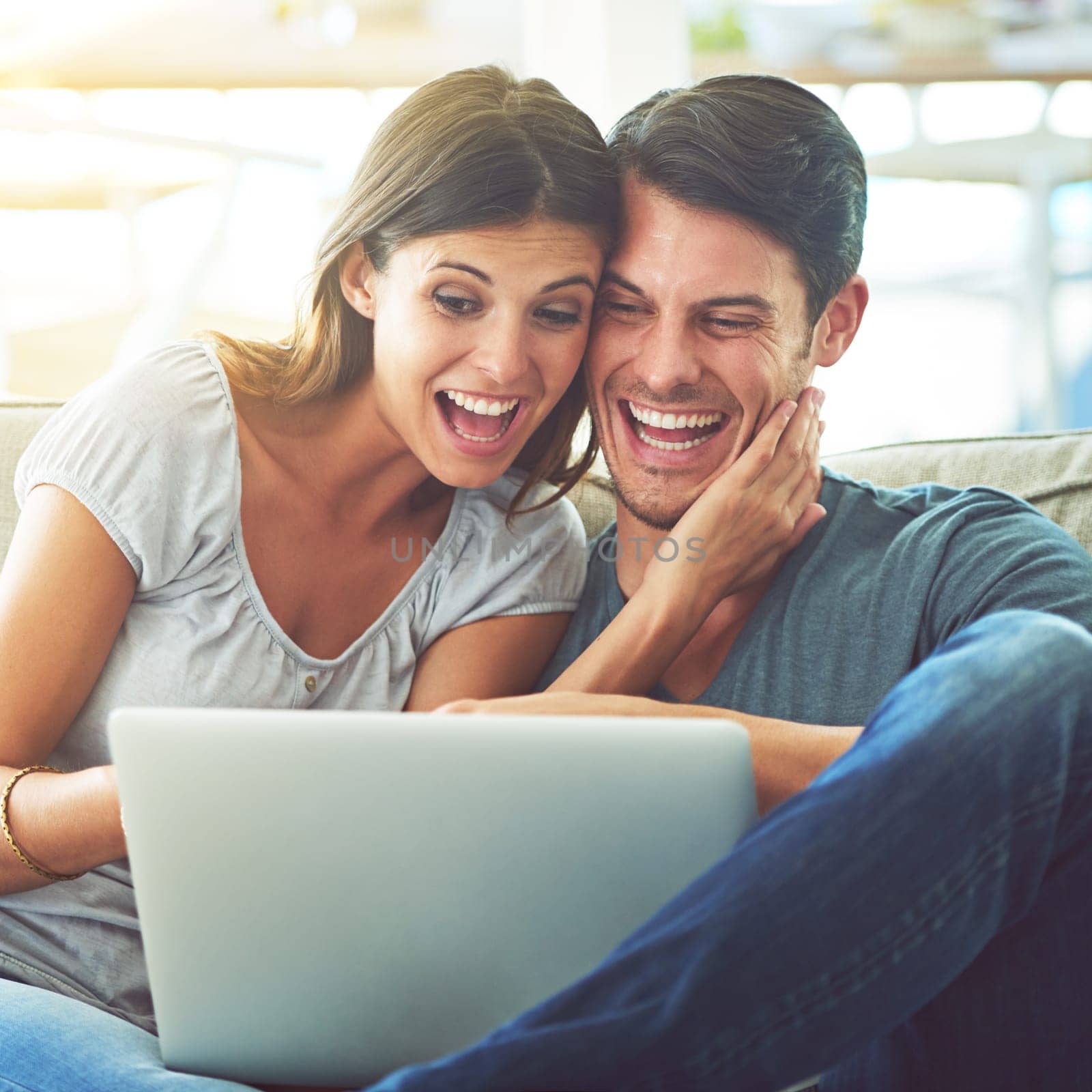 Happy couple, laptop and surprise with good news for winning or online giveaway in living room at home. Excited man or woman with smile on computer in celebration for promo, deal or discount at house.