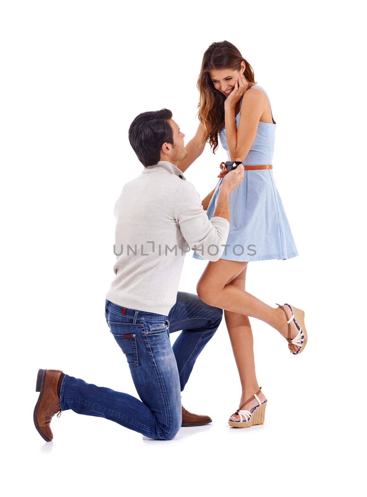 Happy couple, man and woman engagement on a white background celebrate, love and smile in studio. Kneeling, proposal and commitment to marriage, happiness and romance in relationship with a ring by YuriArcurs