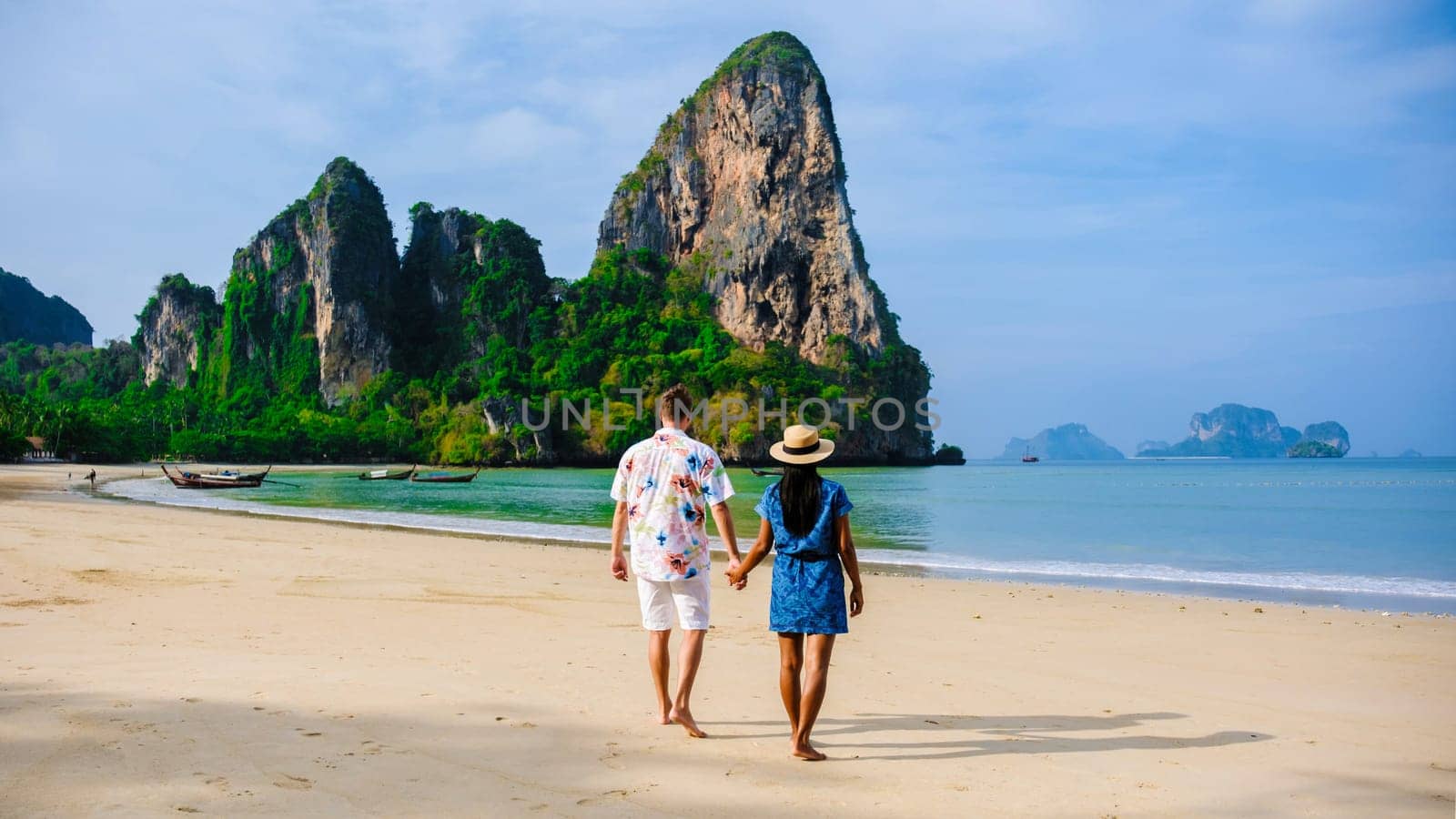 Railay Beach Krabi Thailand, a couple of men and woman on the beach in Thailand by fokkebok