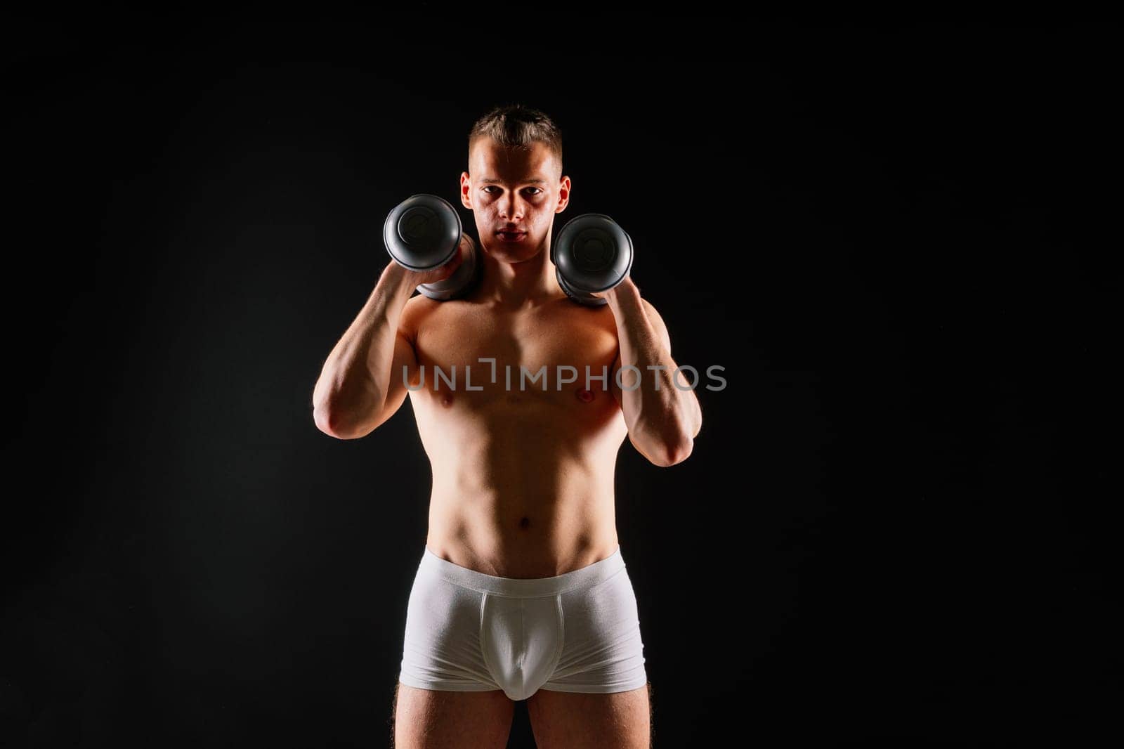 Dumbbells, fitness and man in studio for training, exercise or bodybuilding studio shot. by Zelenin