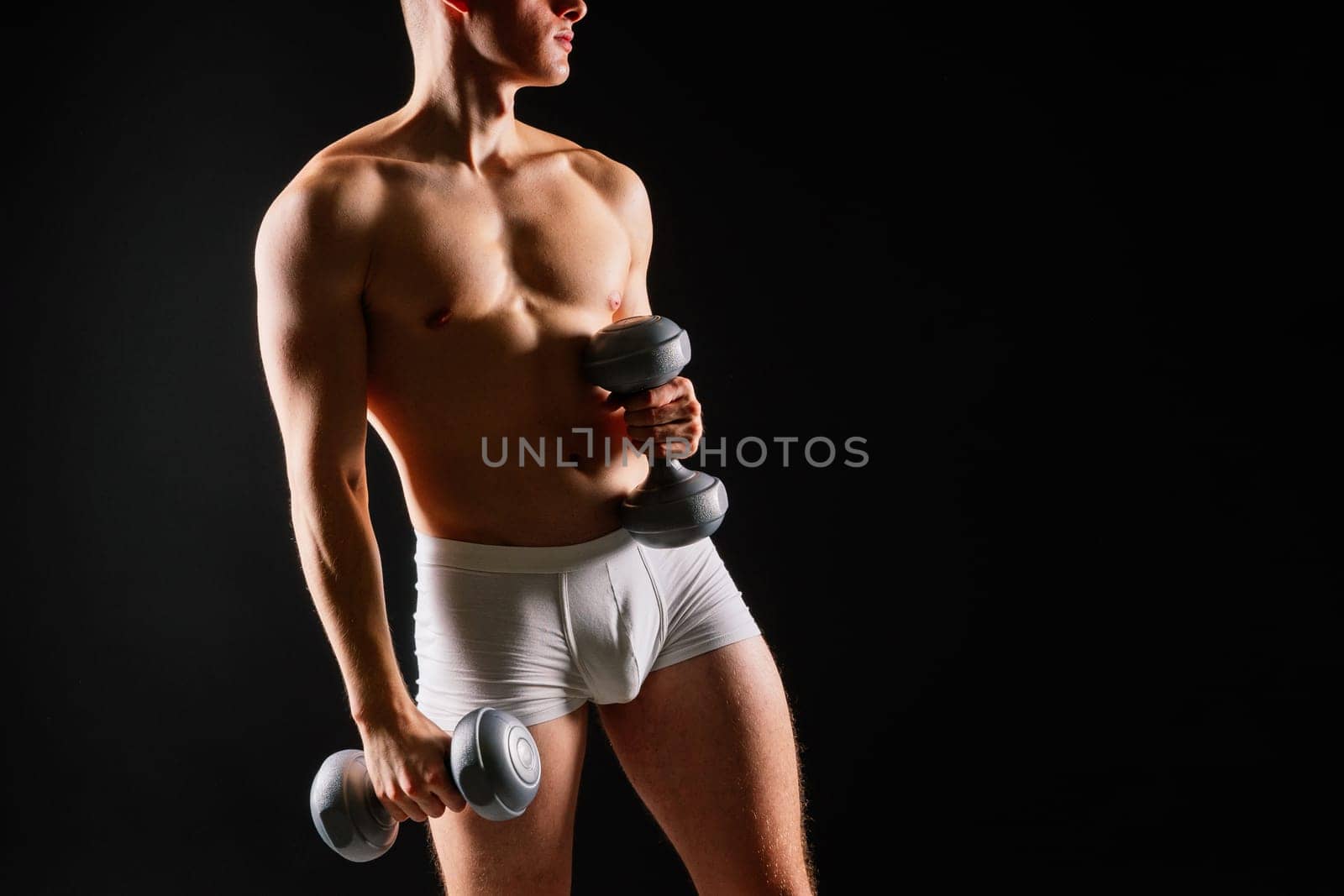 Dumbbells, fitness and man in studio for training, exercise or bodybuilding studio shot. by Zelenin