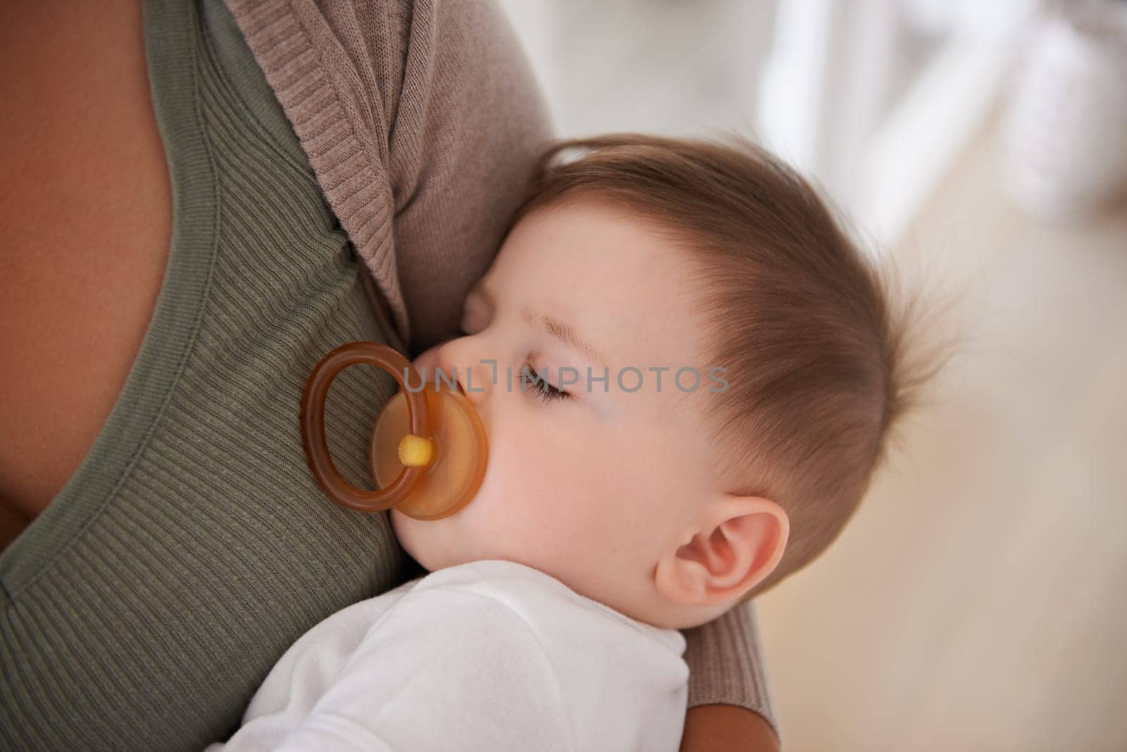 Baby, sleeping and pacifier with relax on mother for healthy development, growth and tired in bedroom. Child, rest and dummy in mouth with nap, dreaming and wellness in nursery for comfort and trust.