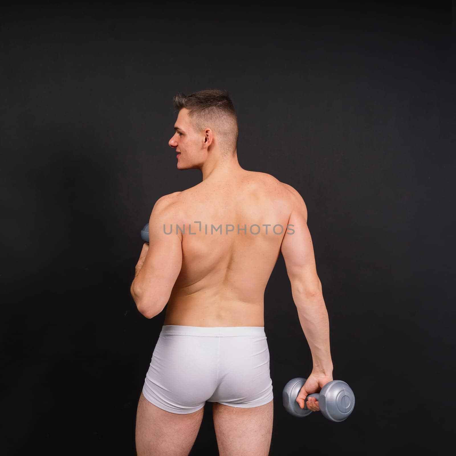 Dumbbells, fitness and man in studio for training, exercise or bodybuilding studio shot. by Zelenin