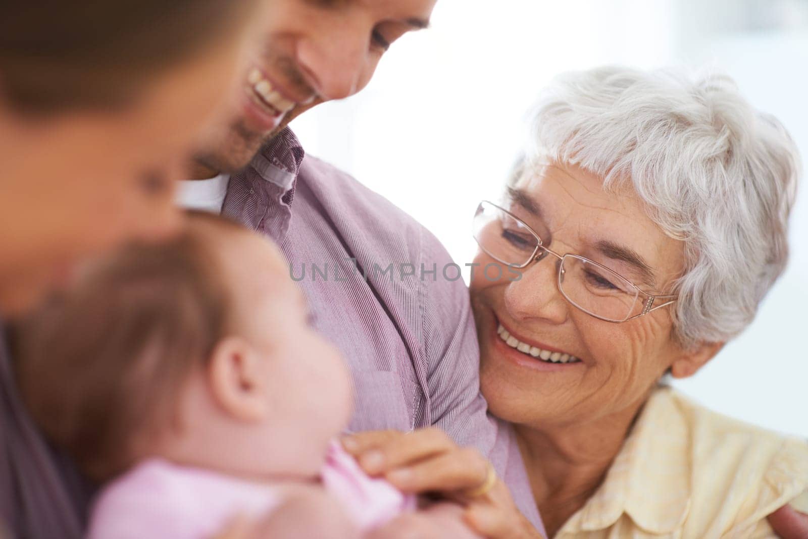 Family, grandmother with baby and parents for happiness at home, people bonding with love and relationship. Support, trust and care with old woman meeting young child, smile for pride and generations.