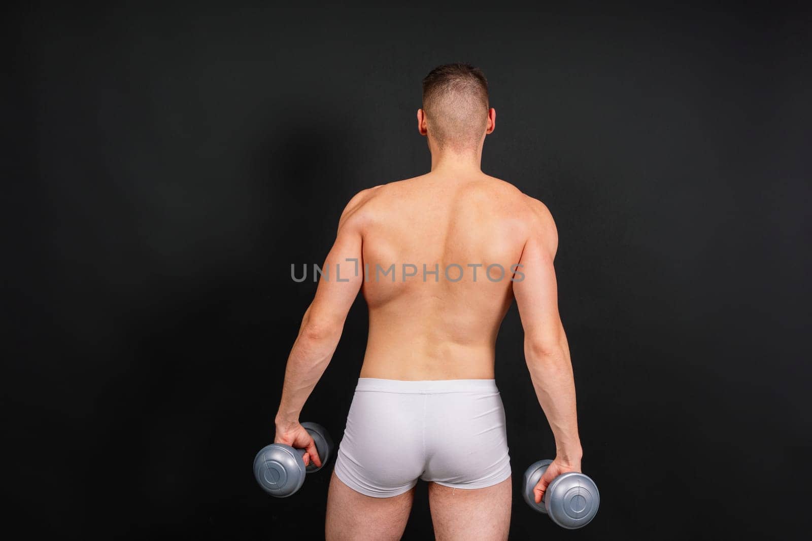 Dumbbells, fitness and man in studio for training, exercise or bodybuilding studio shot. by Zelenin