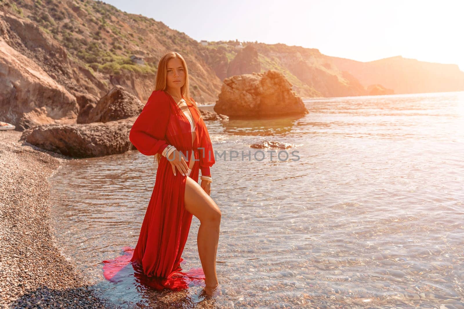 woman sea red dress Happy woman in a flying red dress and with long hair, stands on the seashore by Matiunina
