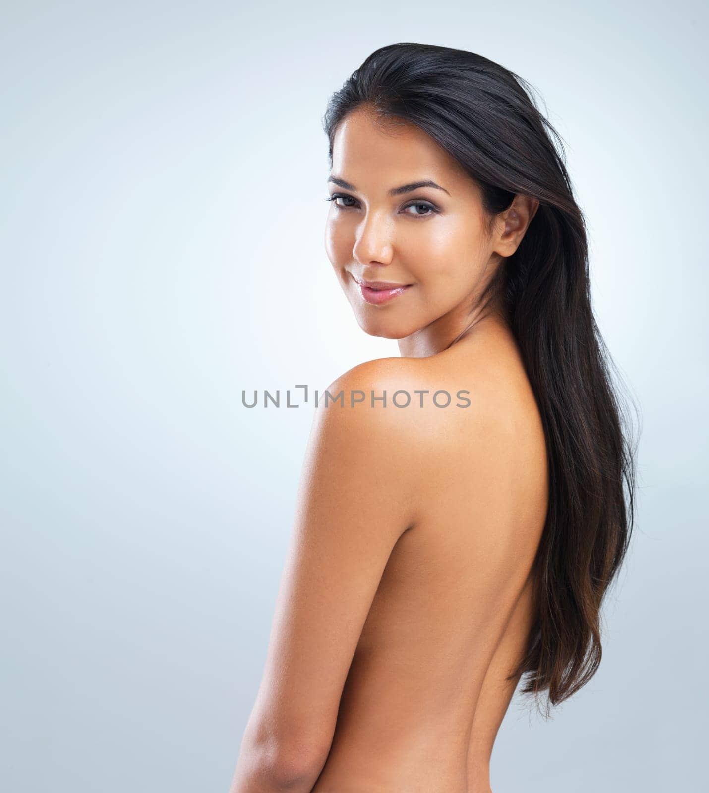 Woman, beauty and hair with cosmetics, portrait of model in studio with shine and keratin treatment on grey background. Haircare, cosmetology and touching skin for wellness with texture and growth.