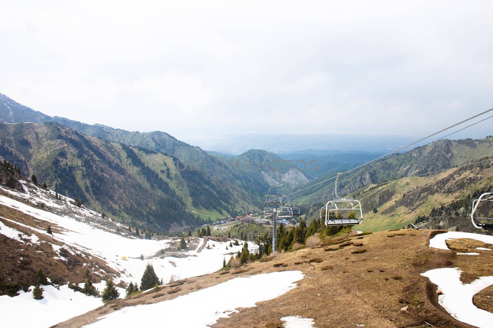 Picturesque Mountain Landscape with Lush Greenery and Snow-capped Peaks in the Distance by Pukhovskiy