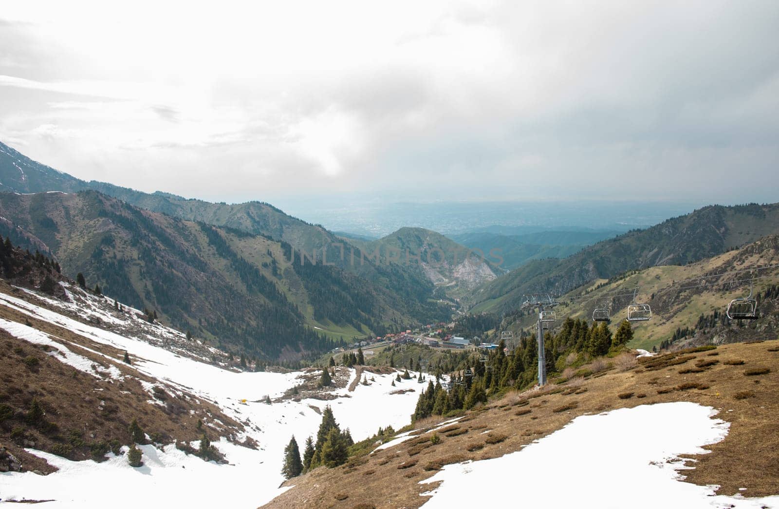 Picturesque Mountain Landscape with Lush Greenery and Snow-capped Peaks in the Distance by Pukhovskiy