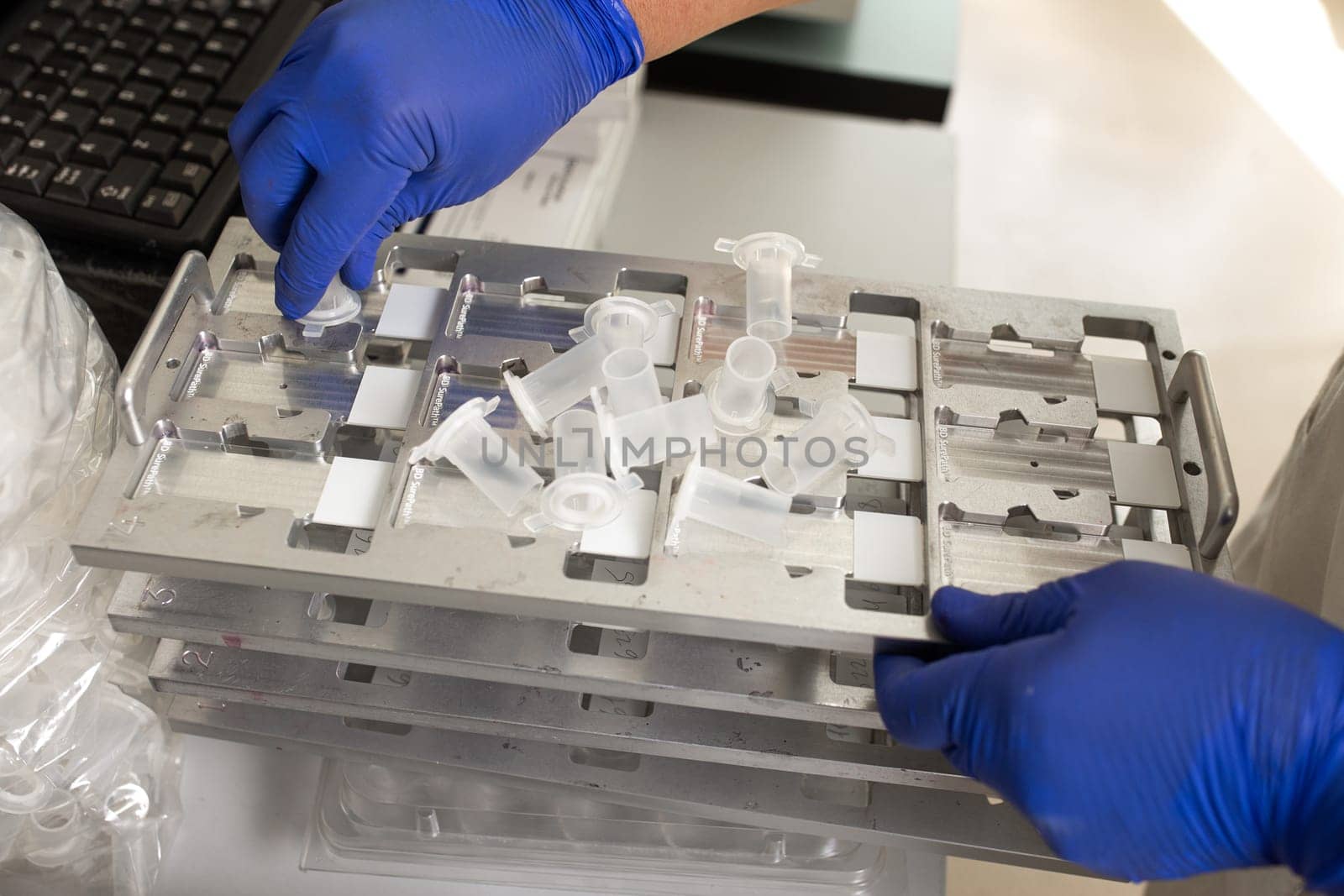 Lab technician works with gloves in hospital.