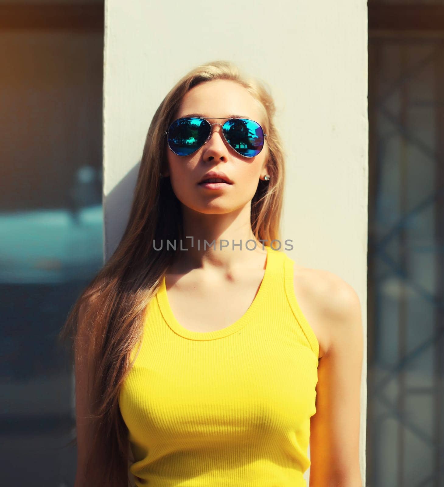 Portrait of modern caucasian young blonde woman posing in sunglasses by Rohappy