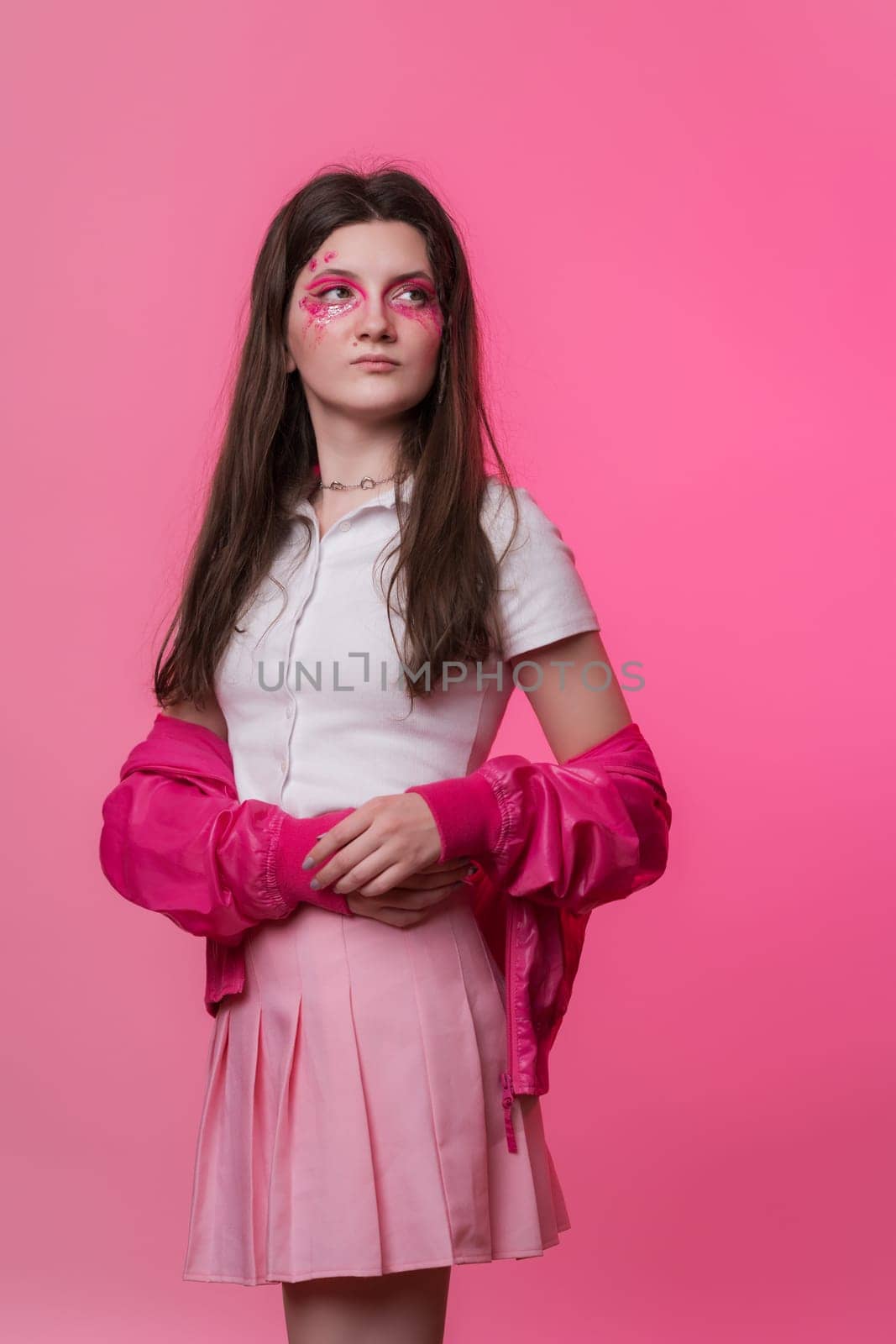 Hipster female with pink stage make-up painted on face, dressed in pink jacket, skirt, white t-shirt by Alexander-Piragis