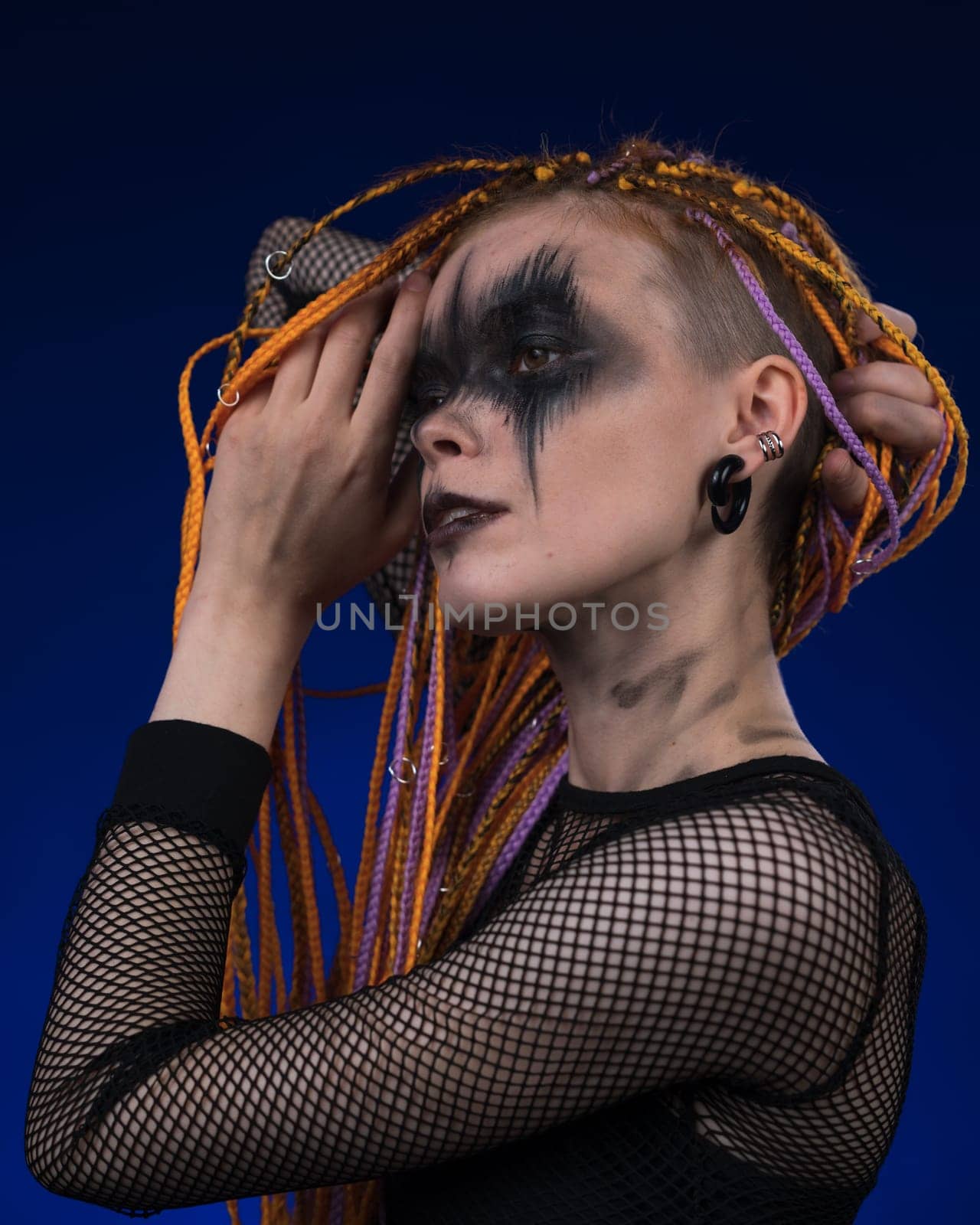 Female with horror black stage makeup painted on face and without dangerous dreadlocks hairstyle by Alexander-Piragis