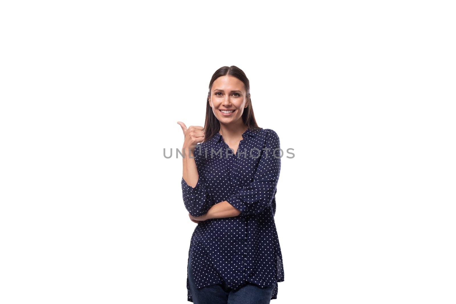 young european slender brunette woman in blue clothes points her hand to the side. advertising concept by TRMK
