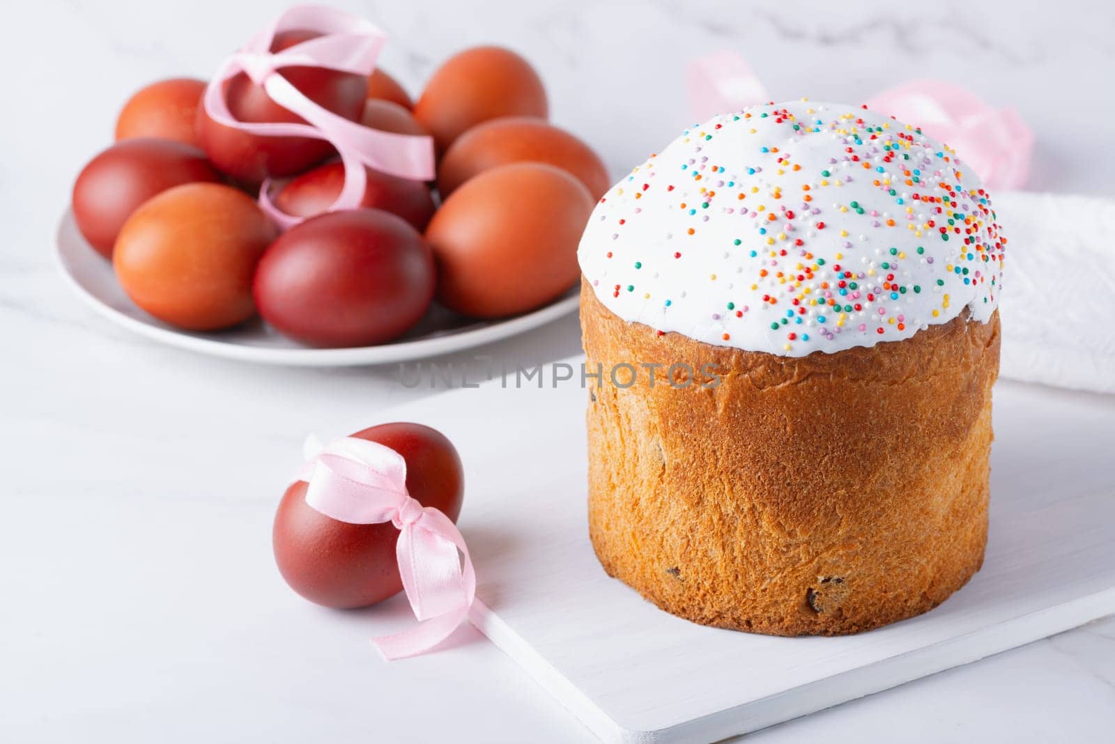Delicious Easter cakes and eggs on light background by NataliPopova