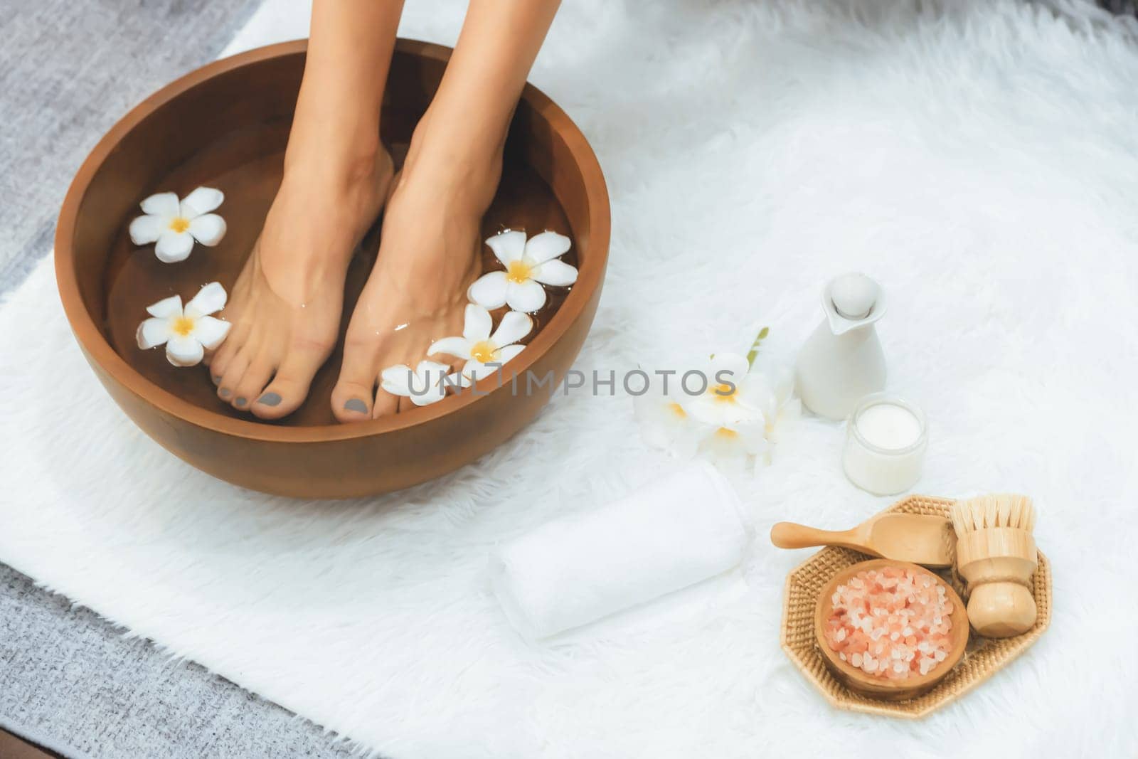 Panorama top view woman indulges in blissful foot massage at luxurious spa salon while masseur give reflexology therapy in gentle day light ambiance resort or hotel foot spa. Quiescent