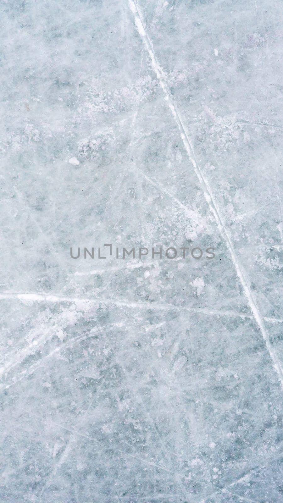 Ice background with marks from skating and hockey, blue texture of rink surface with scratches by Mariakray