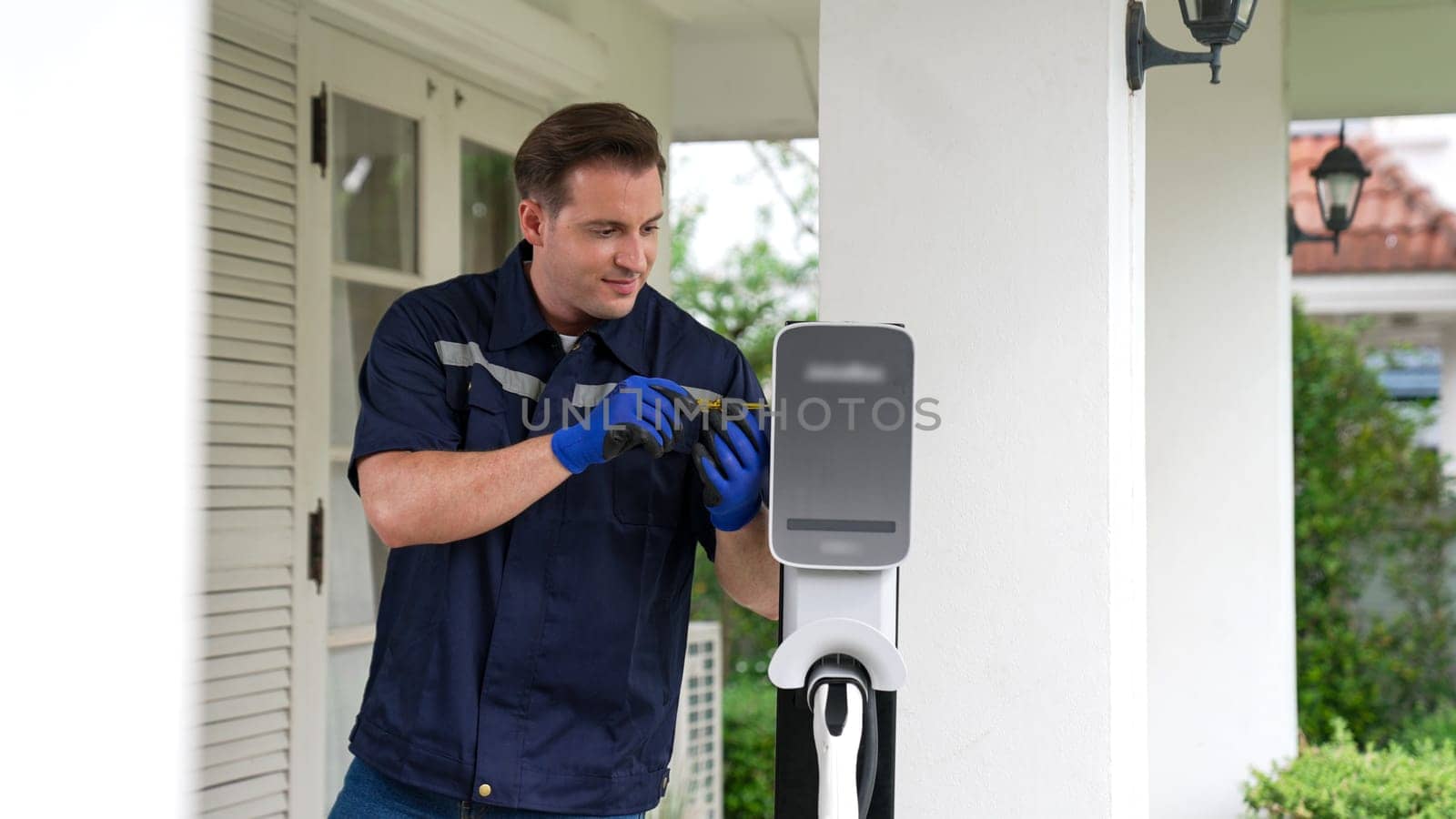Qualified technician install home EV charging station. Synchronos by biancoblue
